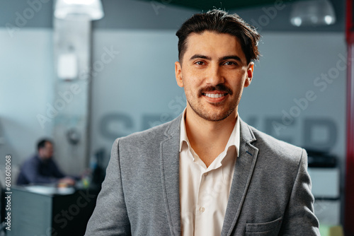 Confident Arab businessman in formal clothes standing in office