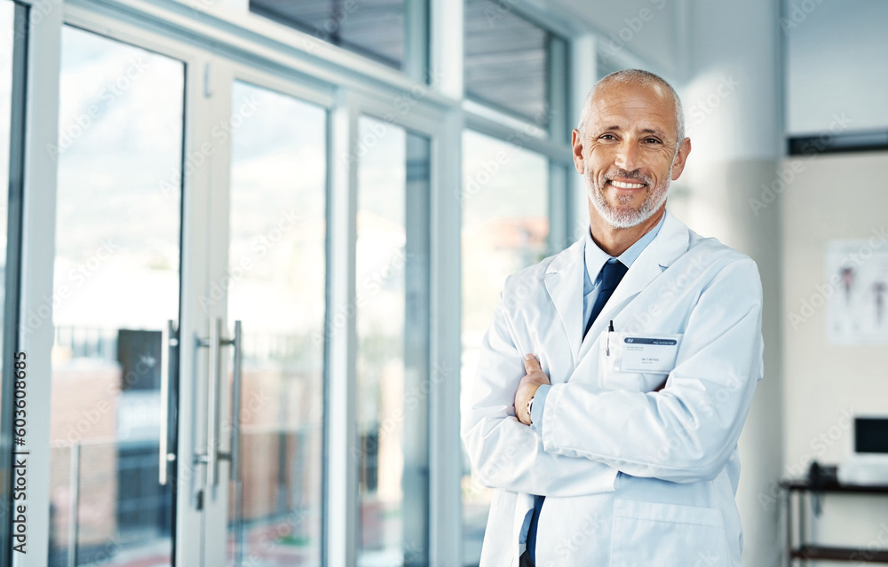 Mature doctor, leadership and portrait with arms crossed in hospital feeling proud from medical work. Healthcare, wellness and professional employee with happiness from health support and job
