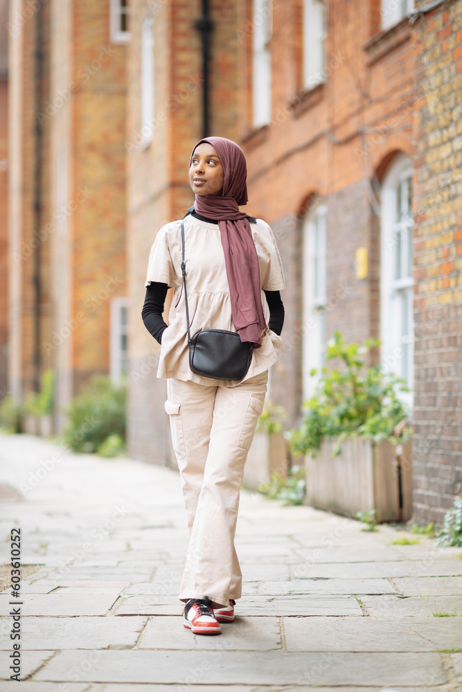 Young woman in hijab standing outdoors