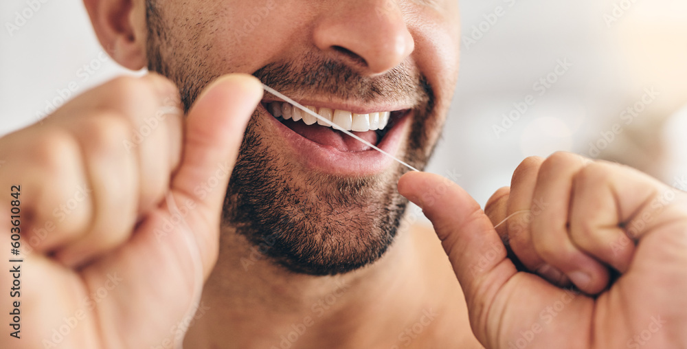 Obraz premium Closeup, face and man flossing teeth at home for healthy dental wellness, plaque and gingivitis. Happy guy, oral thread or cleaning mouth for fresh breath, tooth hygiene and habit to care for smile