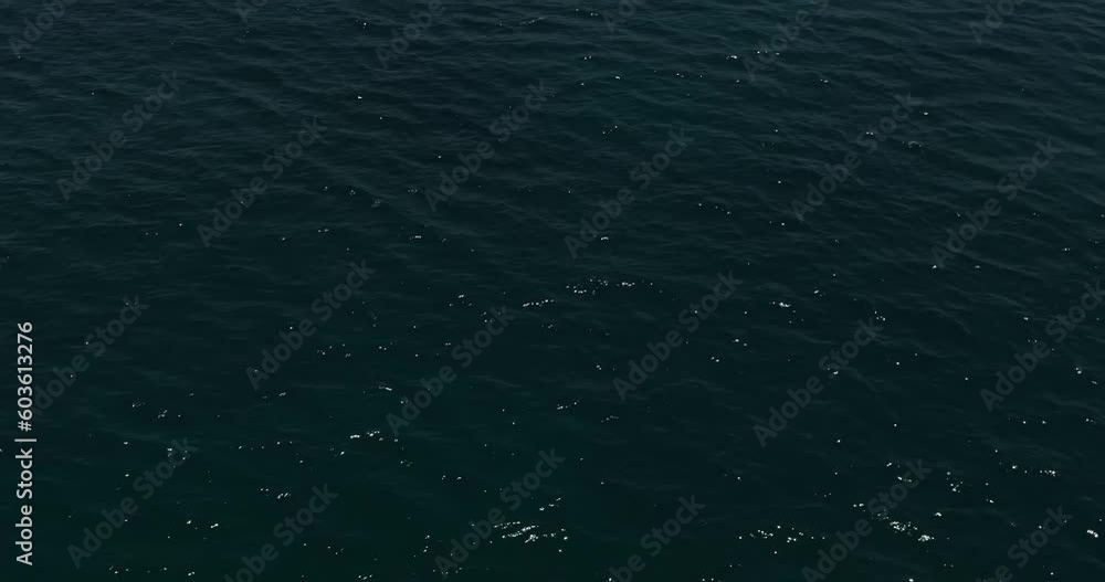 A drone flies over a private road yacht sailing on a calm sea A drone flies over a private road yacht sailing on a calm sea