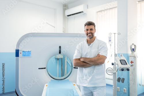 Confident male doctor oncology in magnetic resonance imaging or computed tomography room of a modern hospital.