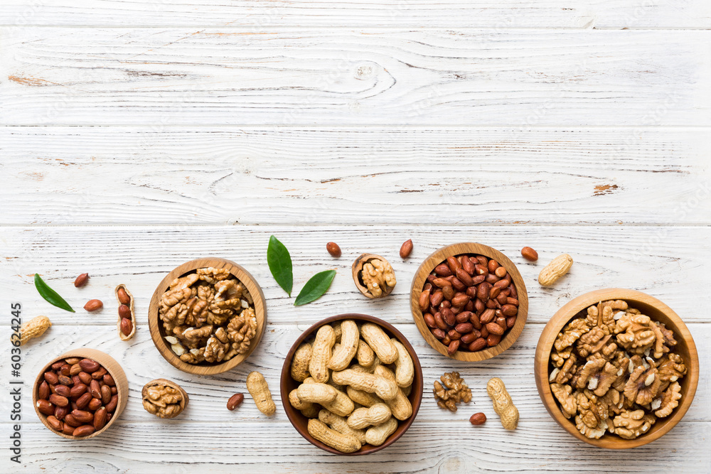 Walnut kernel halves, in a wooden bowl. Close-up, from above on colored background. Healthy eating Walnut concept. Super foods with copy space Walnut kernel halves, in a wooden bowl. Close-up, from above on colored background. Healthy eating Walnut concept. Super foods with copy space