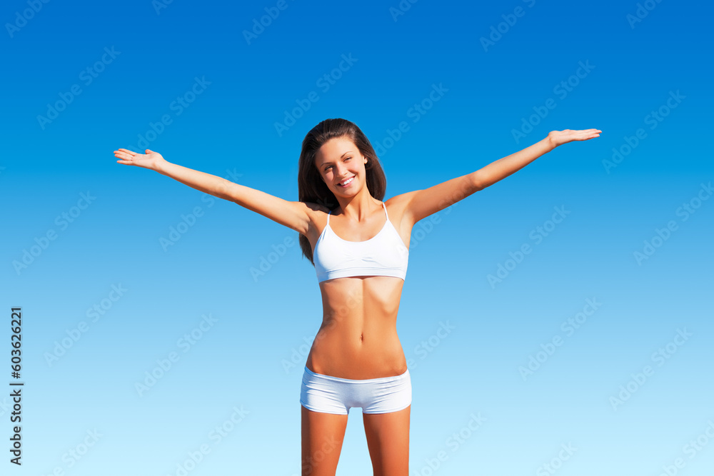Freedom, woman portrait and healthy body outdoor with happiness and relax ready for fitness. Blue sky, young and female person with a happy smile in summer sun and nature with wellness and carefree
