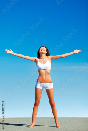 Freedom, fitness woman and healthy body outdoor with happiness and underwear ready for exercise. Blue sky, workout and female person with happy smile and liberation from sun and nature with wellness