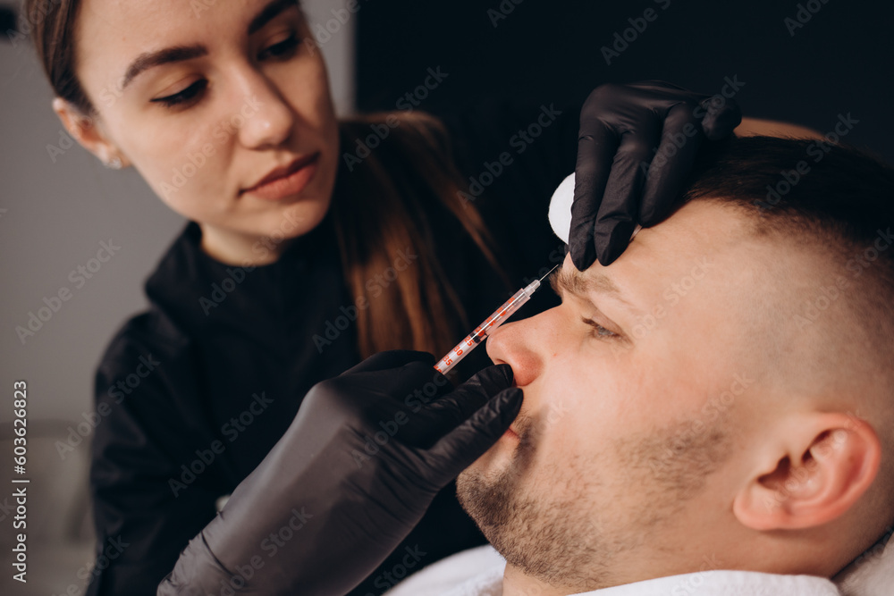 Filler forehead injection for male face in beauty clinic