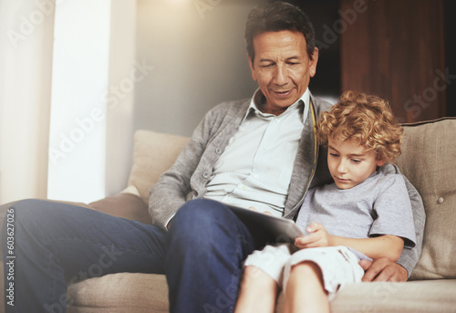 Tablet, child or grandfather streaming movie or film on online subscription in retirement at home to relax. Bond, grandparent or kid loves watching fun videos with a senior or mature old man on sofa