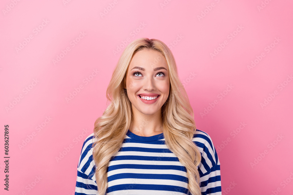 Photo of young happy lady blonde hair wear striped shirt smiling looking up empty space shopping offer isolated on pink color background Photo of young happy lady blonde hair wear striped shirt smiling looking up empty space shopping offer isolated on pink color background