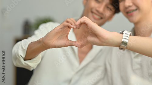 Affectionate same sex male couple making heart with their hands. LGBT, love and lifestyle relationship concept
