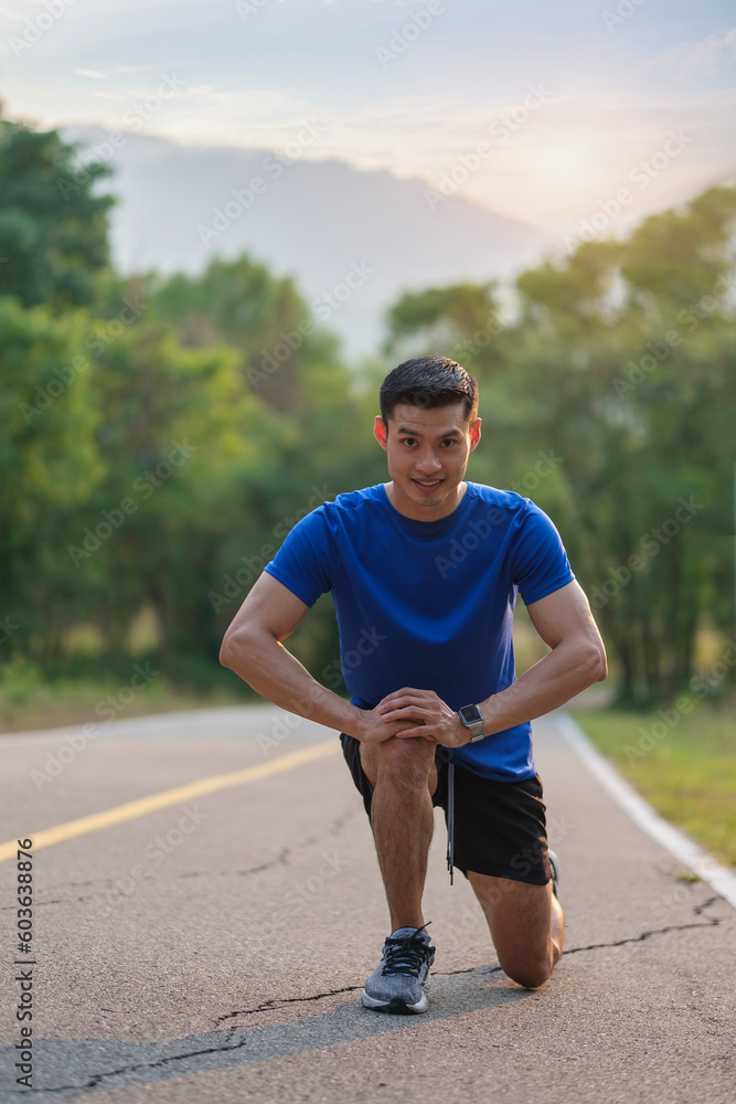 View of sportsman stretching leg before running at the park. Healthy lifestyle. View of sportsman stretching leg before running at the park. Healthy lifestyle.