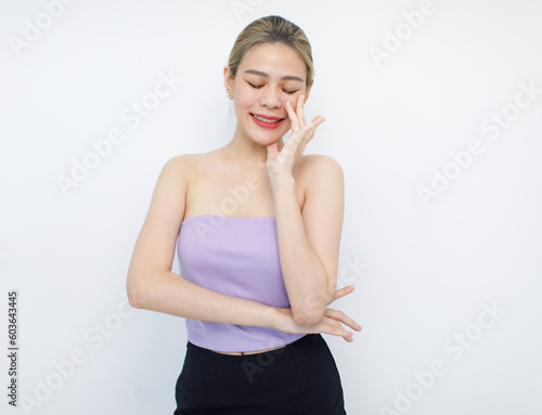 Portrait isolated cutout closeup shot of millennial Asian young beautiful sexy long hair model in seamless tube cropped top standing posing crossed arms look at camera on white background copy space