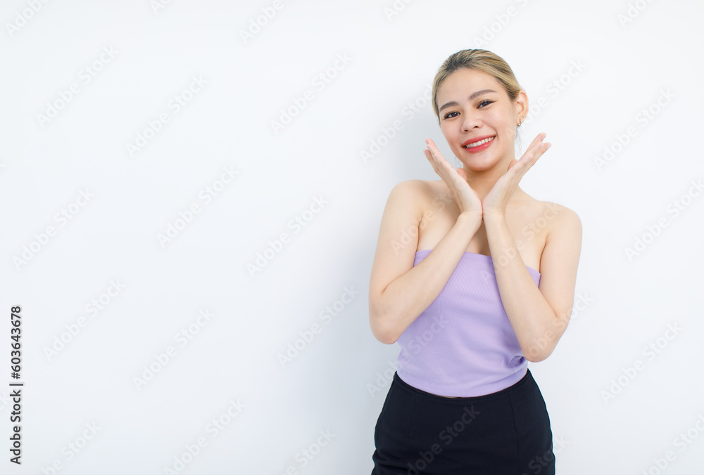 Portrait isolated cutout studio shot of Asian beautiful pretty cheerful female model in tube cropped top shirt standing smiling using hands massaging cream oil moisturizer on face on white background Portrait isolated cutout studio shot of Asian beautiful pretty cheerful female model in tube cropped top shirt standing smiling using hands massaging cream oil moisturizer on face on white background