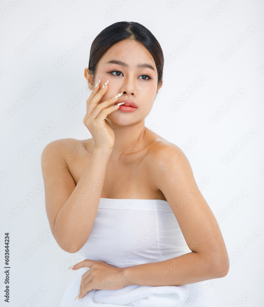 Isolated cutout studio shot millennial Asian beautiful pretty sexy female model in tube cropped top shirt standing smiling holding hand on face showing presenting painting nails on white background Isolated cutout studio shot millennial Asian beautiful pretty sexy female model in tube cropped top shirt standing smiling holding hand on face showing presenting painting nails on white background
