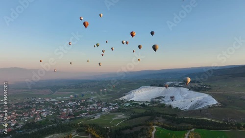 Hot air balloons and Natural travertine pools at sunrise in Pamukkale, 