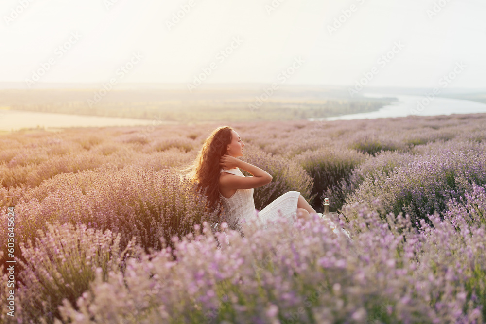 Peaceful girl enjoy rest and tranquility at summer picnic. Girls enjoying picnic time and food outdoors on the lavender field.