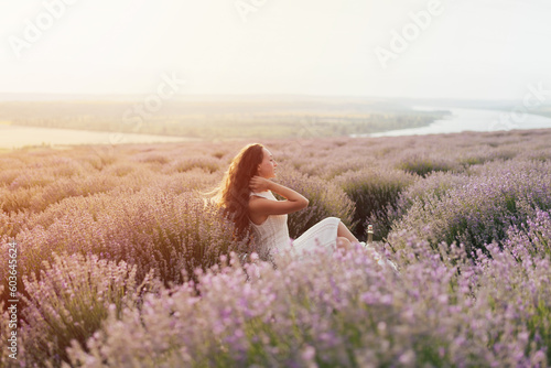 Obraz na płótnie Peaceful girl enjoy rest and tranquility at summer picnic. Girls enjoying picnic time and food outdoors on the lavender field.
w salonie