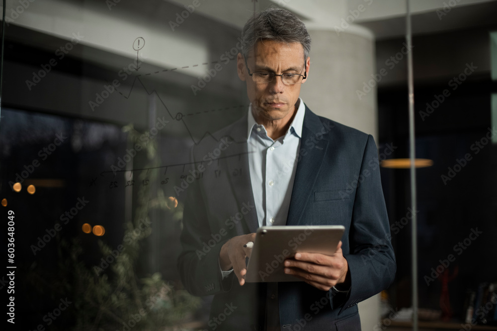 Portrait of successful businessman in office. Man writing on the glass board in office. Portrait of successful businessman in office. Man writing on the glass board in office.