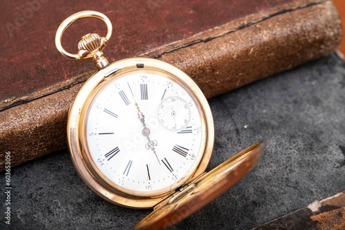 vintage gold pocket watch longines isolated on white background, pocket watch on books background