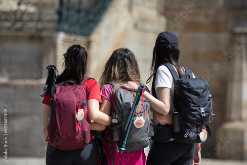 Pilgrims from the Camino de Santiago arrive at the Plaza del Obradoiro because they have finished their pilgrimage