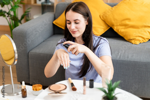 Woman applying foundation on her hand.