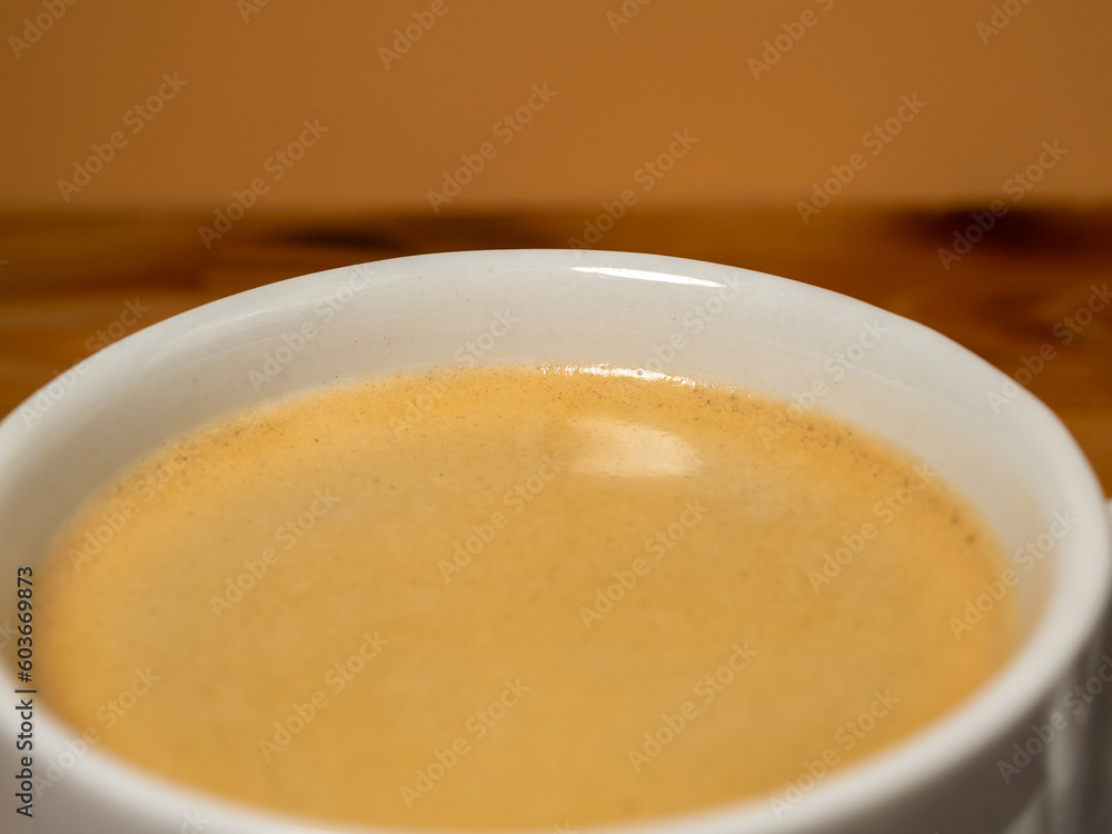 Cup of coffee on a wooden background. Cup of coffee closeup. Cup of coffee on a wooden background. Cup of coffee closeup.