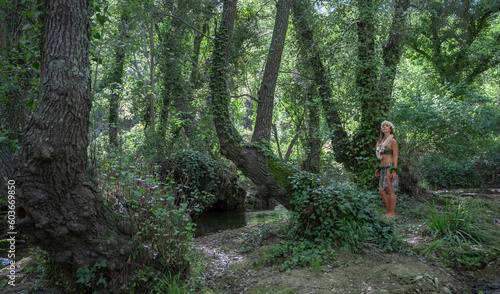 A young hula dancer in the middle of the forest observing the jungle.