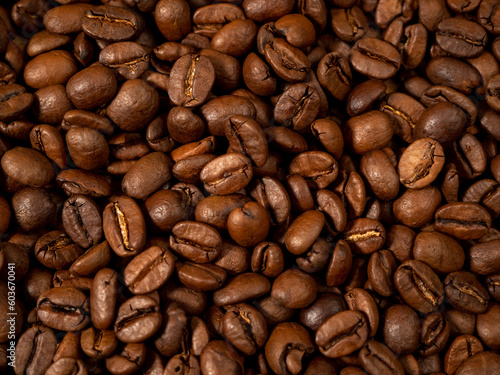 Background from roasted coffee beans. Scattered coffee beans. Coffee beans close up. © Jakob