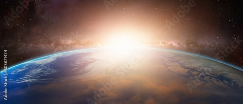 Fototapeta Naklejka Na Ścianę i Meble -  Planet Earth with amazing sunset in front of the Milky Way galaxy 