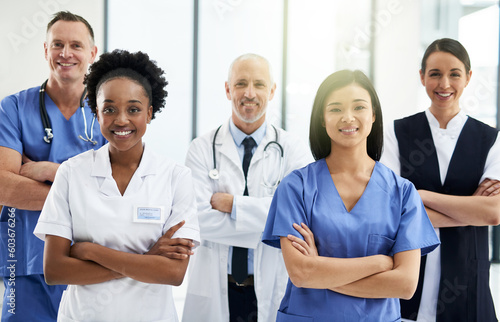 Confidence, crossed arms and portrait of team of doctors standing in the hallway with collaboration. Happy, diversity and group of healthcare workers in the corridor of a medical clinic or hospital.