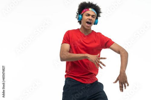 African american guy in headphones looking enjoiyed and dancing