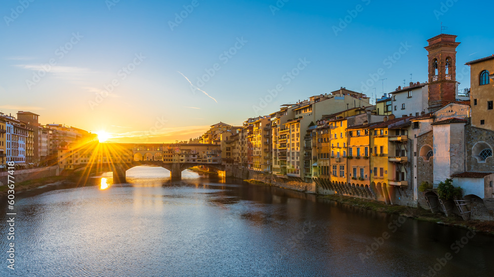 A rising sun above the Ponte Vecchio in Florence early in the morning.