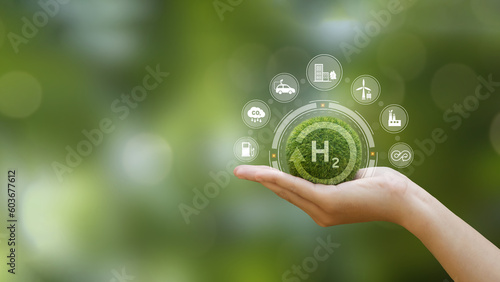 Hand of human holding green earth with the icon of H2 for Clean hydrogen energy concept.Environment, eco friendly industry and alternative energy. net zero target. Reducing greenhouse gas emissions. photo