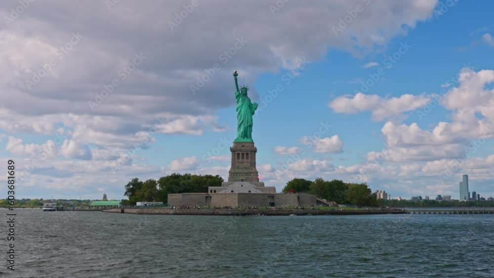 View of Statue of Liberty on Liberty island in New York on background blue sky with white clouds. View of Statue of Liberty on Liberty island in New York on background blue sky with white clouds.