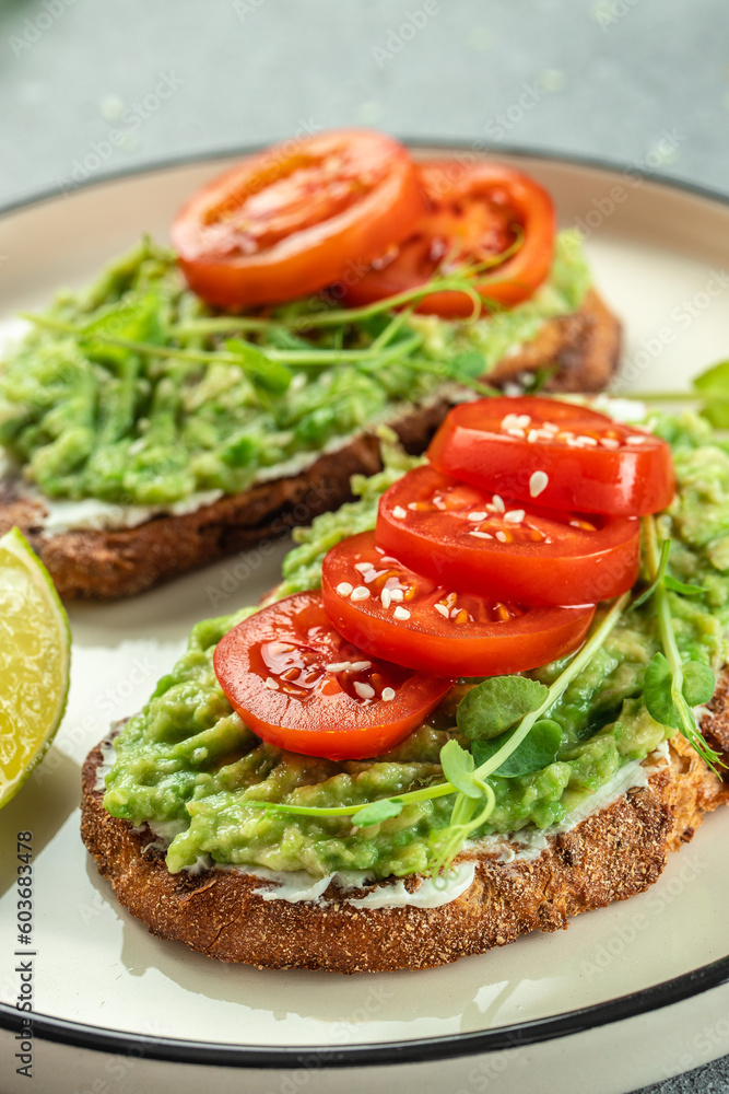 Avocado Toast and tomatoes on light background. Vegetarian food. Vegan menu. place for text, top view