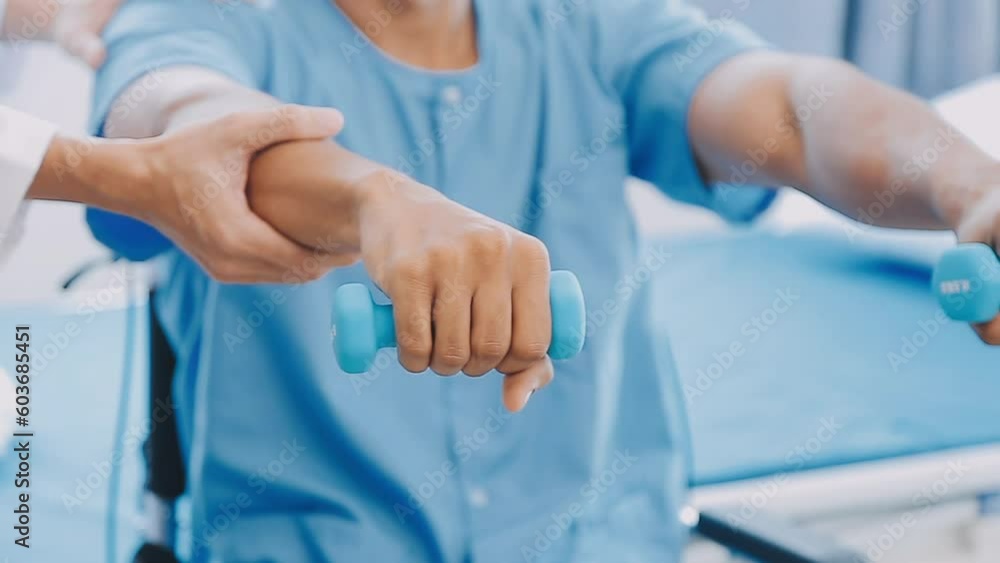 Doctor or Physiotherapist working examining treating injured arm of athlete male patient, stretching and exercise, Doing the Rehabilitation therapy pain in clinic. Doctor or Physiotherapist working examining treating injured arm of athlete male patient, stretching and exercise, Doing the Rehabilitation therapy pain in clinic.