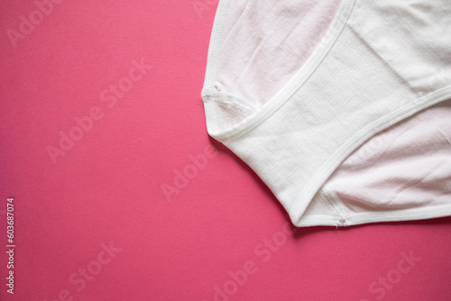 Top view of women's white panties on a pink background. Detail, gusset close-up. High seamless plain, part. Concept: top view advertising, shopping, advertising, mockup, copy space