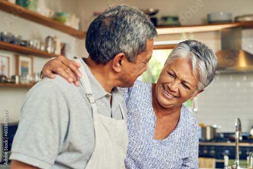 Cooking, hug and old couple in kitchen with smile, healthy marriage bonding in home and helping with dinner. Happiness, help and love, senior man and woman with happy face, meal prep and retirement.