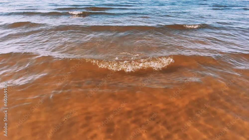 Transparent wavy water on the sea coast. Sandy beach. Transparent wavy water on the sea coast. Sandy beach.