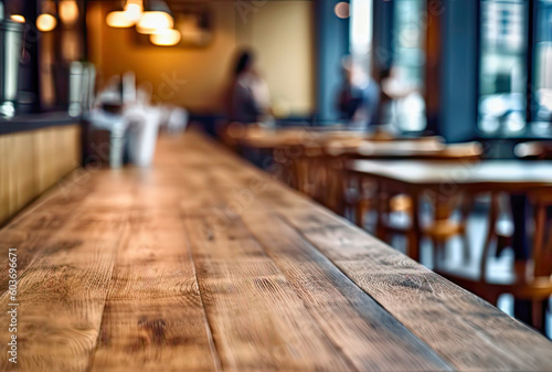 Empty wooden table and blurred background of people in a cafe or restaurant