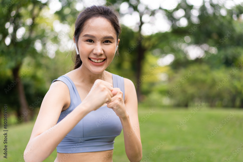 Fitness Asian Girl in tight sportswear doing exercises and punching boxing footwork cardio exercise in park. Female student boxer motivation. Fitness Asian Girl in tight sportswear doing exercises and punching boxing footwork cardio exercise in park. Female student boxer motivation.