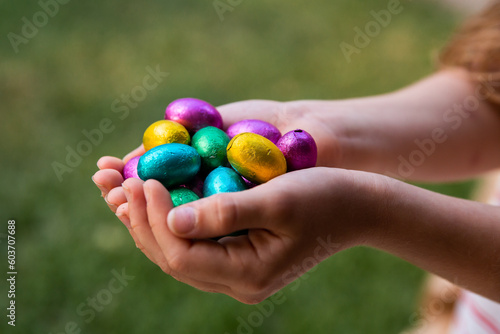 heaps of easter eggs being held by a child photo