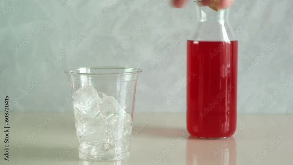 Man prepares a soft drink with ice in plastic disposable cup. Take away, food. Refreshing summer drink. Man prepares a soft drink with ice in plastic disposable cup. Take away, food. Refreshing summer drink.