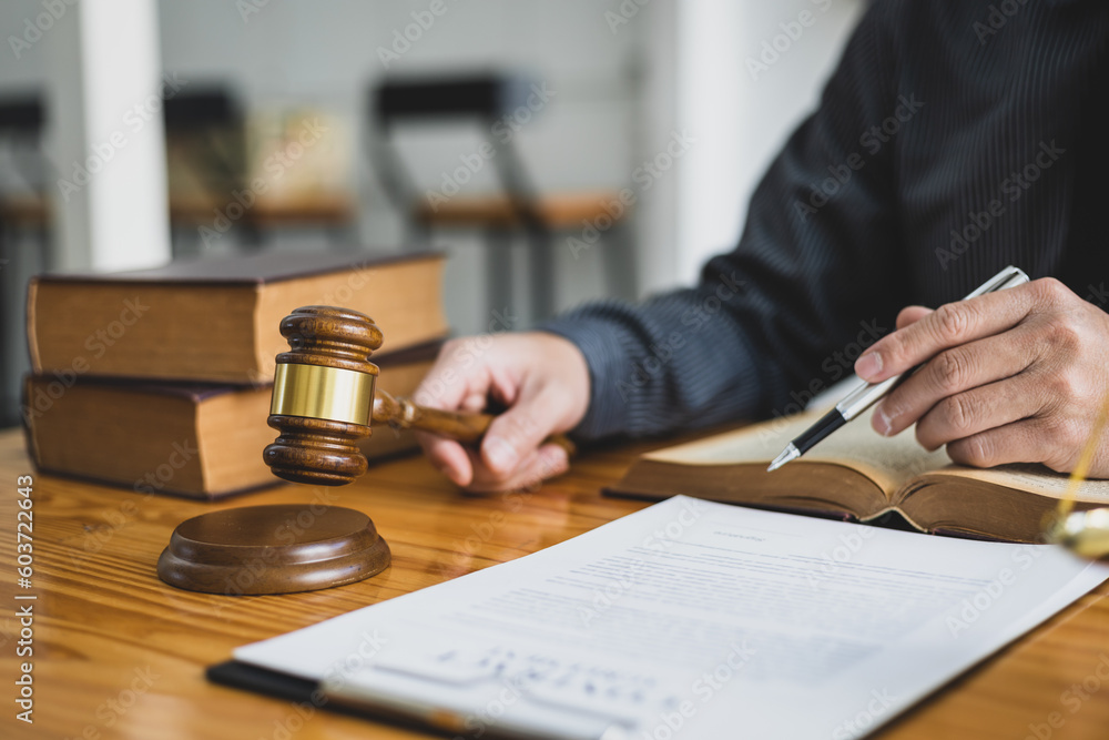 Lawyer reading a book and working in a law firm, Legal counsel and justice concept. Lawyer reading a book and working in a law firm, Legal counsel and justice concept.