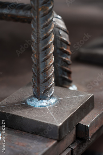 A metal bar welded to a steel pad