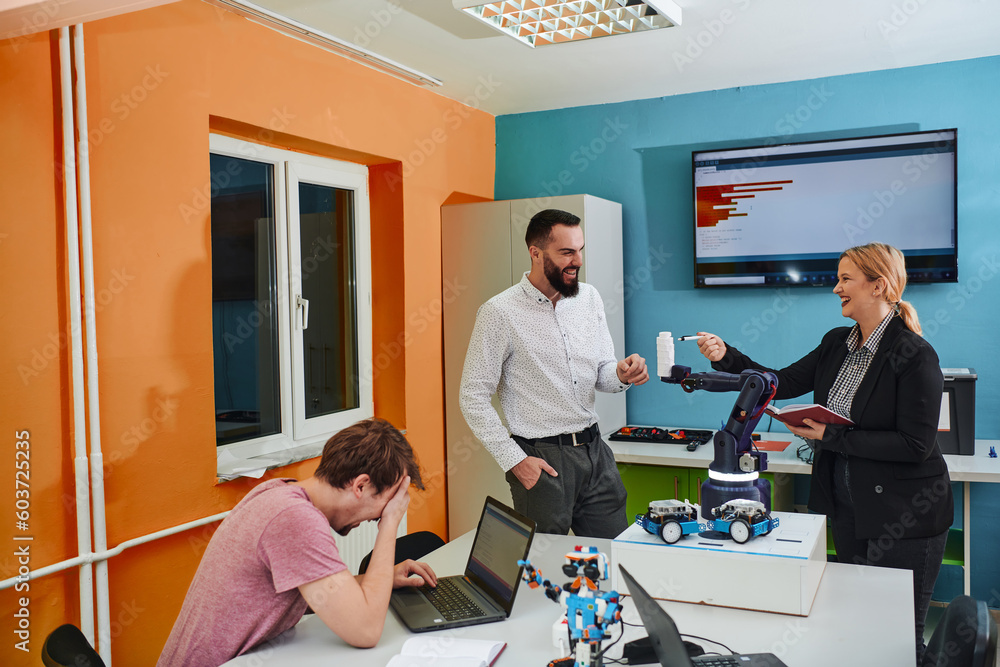 Obraz premium A group of colleagues working together in a robotics laboratory, focusing on the intricate fields of robotics and 3D printing. Showcase their dedication to innovation, as they engage in research