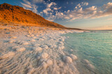 Landscapes from the Dead Sea in the light of the golden hour - interesting salt formations make an amazing impression.