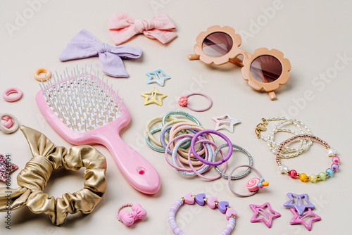 Set of baby girl hair accessories. Fashion hair bows, hair brush, hair clips, hairpins and hair elastics.  Hairstyles for girls with stylish accessory.