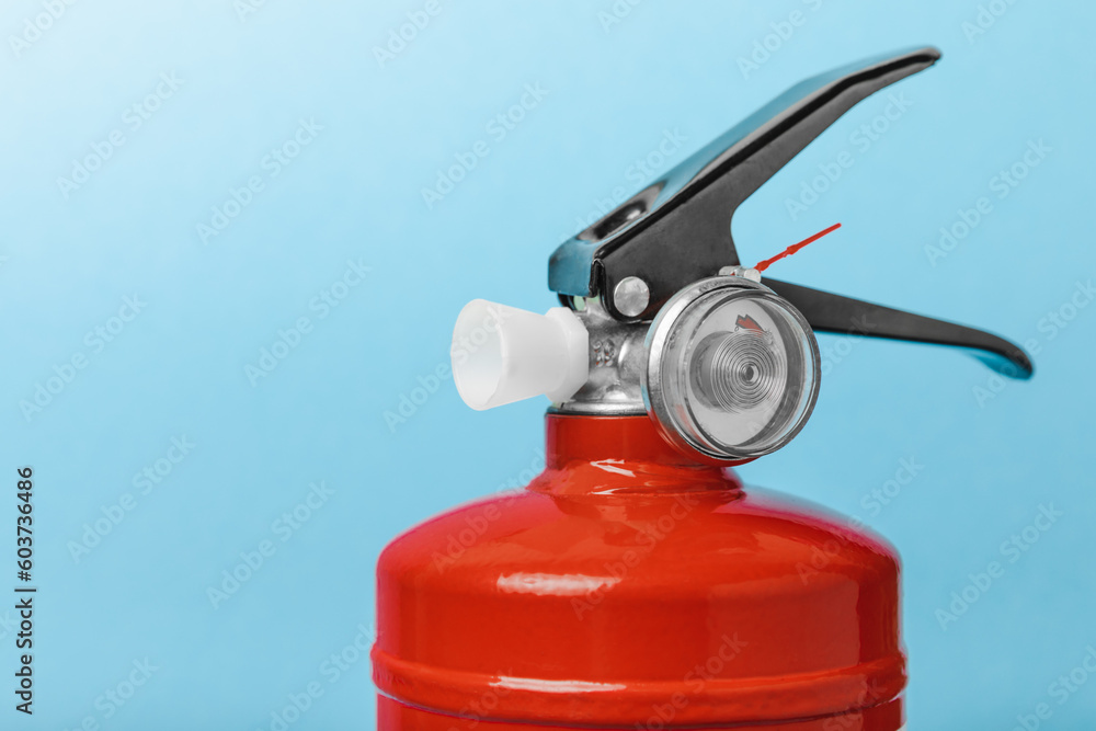 Fire extinguisher on a blue background . Fire protection, home fire extinguisher. home security concept. Place for text. Copy space.banner Fire extinguisher on a blue background . Fire protection, home fire extinguisher. home security concept. Place for text. Copy space.banner