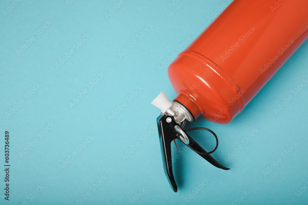 Fire extinguisher on a blue background . Fire protection, home fire extinguisher. home security concept. Place for text. Copy space.banner Fire extinguisher on a blue background . Fire protection, home fire extinguisher. home security concept. Place for text. Copy space.banner