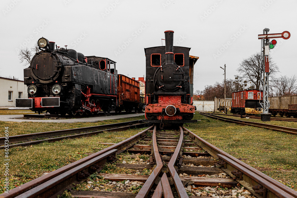 Obraz premium Retro locomotive, steam train parked in an outdoor depot.
